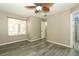 Bedroom featuring light wood-look floors, lighted ceiling fan and access to bathroom at 620 Glenwood Ct # 79, Altamonte Springs, FL 32714