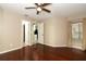Bedroom featuring hardwood floors, lighted ceiling fan and doors to additional rooms at 620 Glenwood Ct # 79, Altamonte Springs, FL 32714