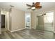 Bedroom featuring light wood-look floors, lighted ceiling fan and doors to additional rooms at 620 Glenwood Ct # 79, Altamonte Springs, FL 32714