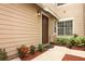 Charming entryway with a brown front door, red mulch, and verdant landscaping at 620 Glenwood Ct # 79, Altamonte Springs, FL 32714
