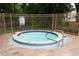 The relaxing hot tub features easy-access steps, surrounded by safety fencing, is the perfect amenity for residents at 620 Glenwood Ct # 79, Altamonte Springs, FL 32714