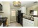Traditional kitchen featuring tile floors, dark appliances and countertops, and decorative stained-glass lighting at 620 Glenwood Ct # 79, Altamonte Springs, FL 32714