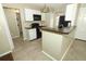Functional kitchen with black appliances, a breakfast bar, and ample cabinet space at 620 Glenwood Ct # 79, Altamonte Springs, FL 32714