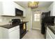 Classic kitchen features white cabinets, black appliances, and a breakfast bar at 620 Glenwood Ct # 79, Altamonte Springs, FL 32714
