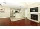 Open-concept living area features hardwood floors, fireplace, and kitchen view at 620 Glenwood Ct # 79, Altamonte Springs, FL 32714