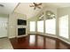 Bright living room featuring wood floors, a fireplace, vaulted ceilings, and large windows at 620 Glenwood Ct # 79, Altamonte Springs, FL 32714