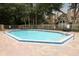 A sparkling pool features a unique shape and is surrounded by a brick deck with lounge chairs, perfect for relaxation at 620 Glenwood Ct # 79, Altamonte Springs, FL 32714
