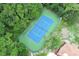 Aerial view of a tennis court surrounded by green trees at 620 Glenwood Ct # 79, Altamonte Springs, FL 32714