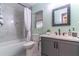 Well-maintained bathroom with marble-style tiling, gray vanity, and shower-tub combination with white curtain at 638 Boniview Ln, Altamonte Springs, FL 32714