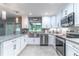 Modern kitchen features stainless steel appliances, white cabinetry, and granite countertops at 638 Boniview Ln, Altamonte Springs, FL 32714