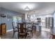 Open kitchen and dining area featuring stainless steel appliances, white cabinets, and modern light fixtures at 638 Boniview Ln, Altamonte Springs, FL 32714