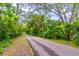 Scenic paved path surrounded by lush greenery and mature trees, perfect for outdoor walks and enjoying nature at 638 Boniview Ln, Altamonte Springs, FL 32714