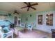 Covered outdoor patio with comfortable seating, ceiling fans, and views of the landscaped backyard at 638 Boniview Ln, Altamonte Springs, FL 32714