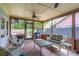 Inviting screened-in porch with ample seating and views of the lush backyard at 638 Boniview Ln, Altamonte Springs, FL 32714
