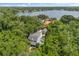 Aerial view of a stunning estate with a pool, and a serene lake backdrop surrounded by trees at 685 Mayo Ave, Maitland, FL 32751