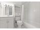 Cozy all-white bathroom with tub and shower combination, mirror, and cabinet at 685 Mayo Ave, Maitland, FL 32751