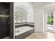 Stylish bathroom featuring a soaking tub, glass enclosed shower, and a window for natural light at 685 Mayo Ave, Maitland, FL 32751