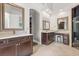 Elegant bathroom with double sinks, granite countertops, and dark wood cabinets with access to closet at 685 Mayo Ave, Maitland, FL 32751