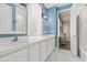 Well-lit bathroom with double sinks, white cabinets, and a shower-tub combination at 685 Mayo Ave, Maitland, FL 32751