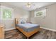 Bedroom featuring a bed, side table, wood floors, and natural light from two windows at 685 Mayo Ave, Maitland, FL 32751