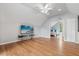 Bright bonus room with hardwood floors, a ceiling fan, and a doorway leading to a bedroom at 685 Mayo Ave, Maitland, FL 32751