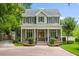 Elegant two-story home featuring a grand front porch with columns, double doors, and meticulous landscaping at 685 Mayo Ave, Maitland, FL 32751