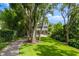 Expansive lawn and brick driveway with mature trees lead to this beautiful home at 685 Mayo Ave, Maitland, FL 32751