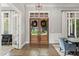 Elegant foyer with double doors, chandelier, hardwood floors, and views of the landscaped front yard at 685 Mayo Ave, Maitland, FL 32751
