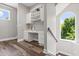 Bright hallway features a built in desk, wood floors, and a large arched window at 685 Mayo Ave, Maitland, FL 32751