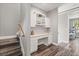 Hallway with built-in desk and cabinets, leading to stairs and a bedroom at 685 Mayo Ave, Maitland, FL 32751