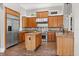 Kitchen with wooden cabinets, stainless steel appliances, and a center island at 685 Mayo Ave, Maitland, FL 32751