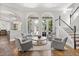 Bright living room with French doors, neutral armchairs, and a statement chandelier at 685 Mayo Ave, Maitland, FL 32751