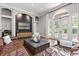 Cozy living room with leather sofas, a large TV, and bright natural light at 685 Mayo Ave, Maitland, FL 32751