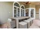 Elegant patio features a dining table set and arched windows for seamless indoor-outdoor entertaining at 685 Mayo Ave, Maitland, FL 32751