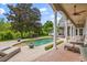 Backyard oasis featuring a large pool, covered patio with columns, and well-manicured landscaping at 685 Mayo Ave, Maitland, FL 32751