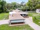 Overhead view showcasing the home's backyard, porte-cochere, brick driveway, and lush surroundings at 740 Florida Blvd, Altamonte Springs, FL 32701
