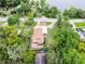 Aerial view of home surrounded by trees with long driveway near the water at 740 Florida Blvd, Altamonte Springs, FL 32701