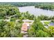 Breathtaking aerial view of a lakeside home surrounded by lush greenery and mature trees at 740 Florida Blvd, Altamonte Springs, FL 32701
