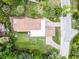 Aerial view of the home and winding driveway with lush landscaping, plus surrounding trees at 740 Florida Blvd, Altamonte Springs, FL 32701