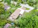 Aerial view of home with mature trees, lush lawn, and winding brick driveway at 740 Florida Blvd, Altamonte Springs, FL 32701
