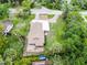 Aerial view of home with long driveway and manicured lawn surrounded by mature trees at 740 Florida Blvd, Altamonte Springs, FL 32701