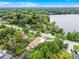 Aerial view of home near the water with lush green lawn and mature trees at 740 Florida Blvd, Altamonte Springs, FL 32701