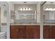 Stylish bathroom with double vanity, granite countertops, mosaic backsplash, and a glass-enclosed shower at 740 Florida Blvd, Altamonte Springs, FL 32701