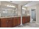 Well-lit bathroom showcasing double sinks, tile backsplash, granite countertops, and a glass-enclosed shower at 740 Florida Blvd, Altamonte Springs, FL 32701
