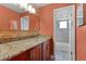 This stylish bathroom has a large mirror, granite countertops, an earth-tone color scheme and a shower/tub at 740 Florida Blvd, Altamonte Springs, FL 32701
