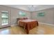 Comfortable bedroom featuring a queen-size bed, two windows, and a brick accent wall at 740 Florida Blvd, Altamonte Springs, FL 32701