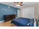 Spacious bedroom with hardwood flooring, ceiling fan, and unique wall decor, providing a paradise at 740 Florida Blvd, Altamonte Springs, FL 32701