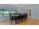 Well-lit dining room boasts a large dark-wood table and chairs, as well as hardwood floors at 740 Florida Blvd, Altamonte Springs, FL 32701