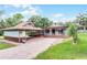 Charming single-story home with a welcoming porch, brick driveway, and covered parking at 740 Florida Blvd, Altamonte Springs, FL 32701