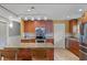 A fully equipped kitchen with an island, providing extra space and seating, with a decorative chandelier at 740 Florida Blvd, Altamonte Springs, FL 32701